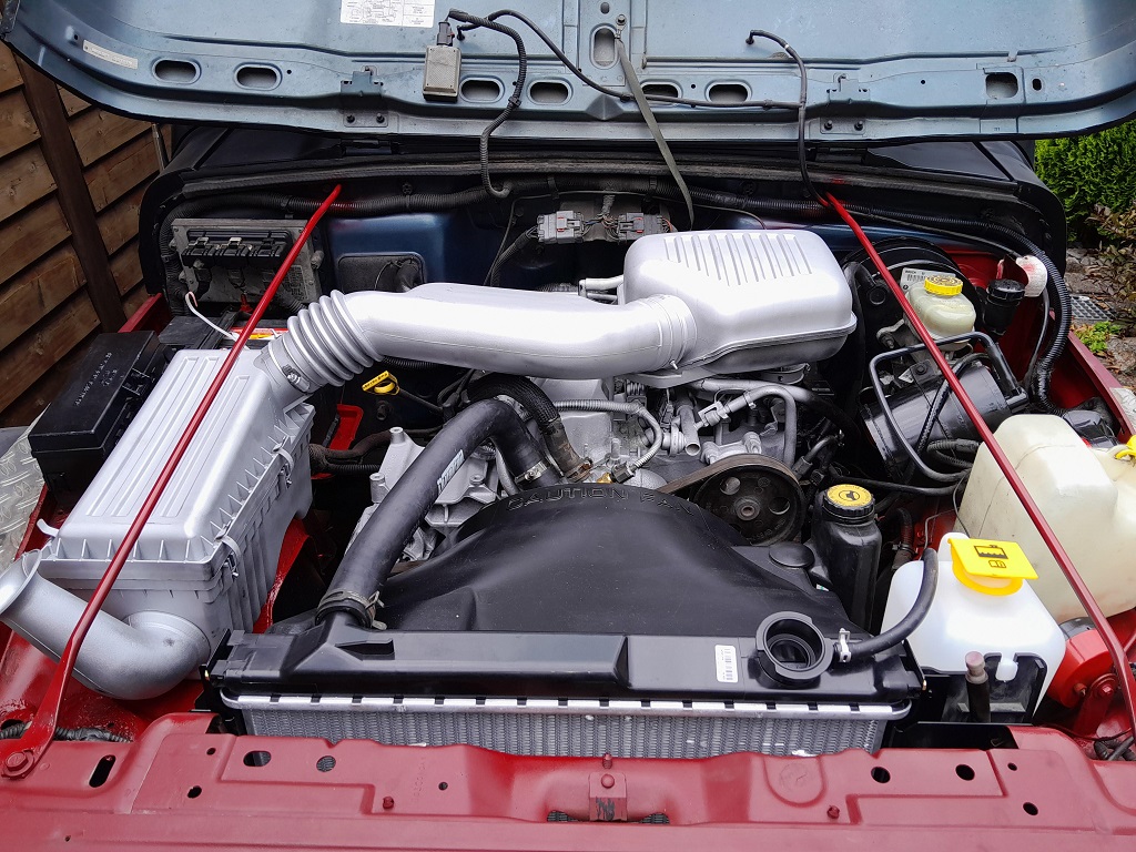 What precautions should be taken when cleaning an engine bay? 