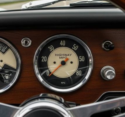 Vintage 1960s sports car dashboard gauge showing highway MPG.
