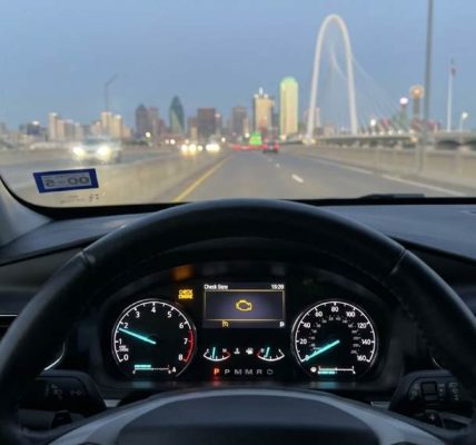 Dallas driver checking engine warning light with diagnostic scanner