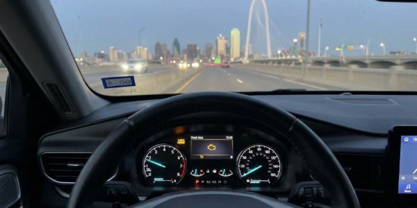 Dallas driver checking engine warning light with diagnostic scanner
