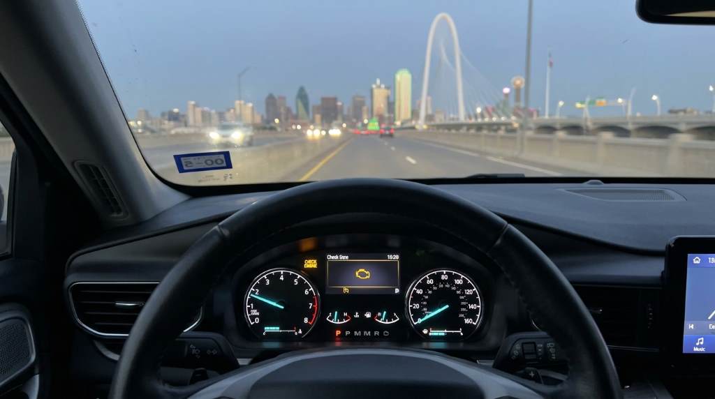 Dallas driver checking engine warning light with diagnostic scanner