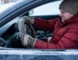 Chicago driver organizing winter emergency gear inside a vehicle trunk