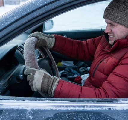 Chicago driver organizing winter emergency gear inside a vehicle trunk