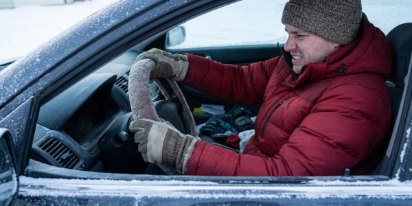 Chicago driver organizing winter emergency gear inside a vehicle trunk