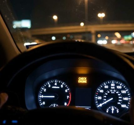 Driver checking dashboard warning lights inside a modern vehicle